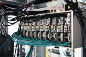 Setup of an IP matrix test. Many small devices connected by cable to an IP matrix.