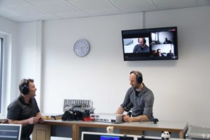 G&D trainers seated at workstations in front of a video wall via which the participants are connected.